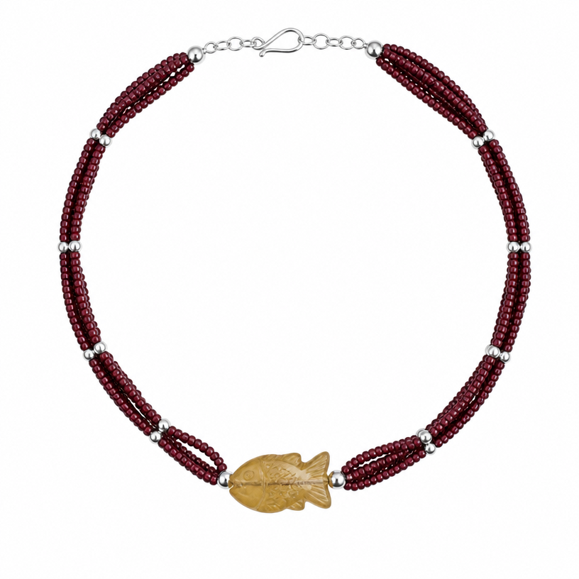 A tribal women's necklace suitable for daily wear. black lines represent triple strand of really small wine red beads with silver representing small spherical white beads that hold the strands together every 1.5 inches. Focal bead is the rough cut yellow fish.
using the attached image as a visual reference, create A tribal women's necklace suitable for daily wear. black lines represent triple strand of really small wine red beads with silver representing small spherical white beads that hold the strands together every 1.5 inches. Focal bead is the rough cut yellow fish.. photorealistic, just the design no text