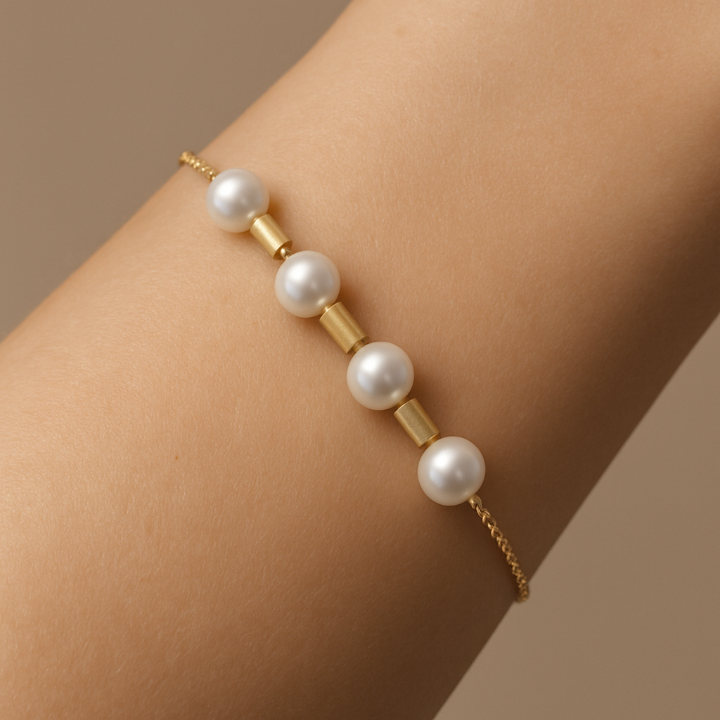 elegant and gentel lookfor a thin hand for a short and delicate girl at a yellow gold bracelet with 4-5 pearls 5cm diameter (or maybe we need smaller pearls?) scatered evenly on the golden chain with nice solid spacers which are golden brushed 