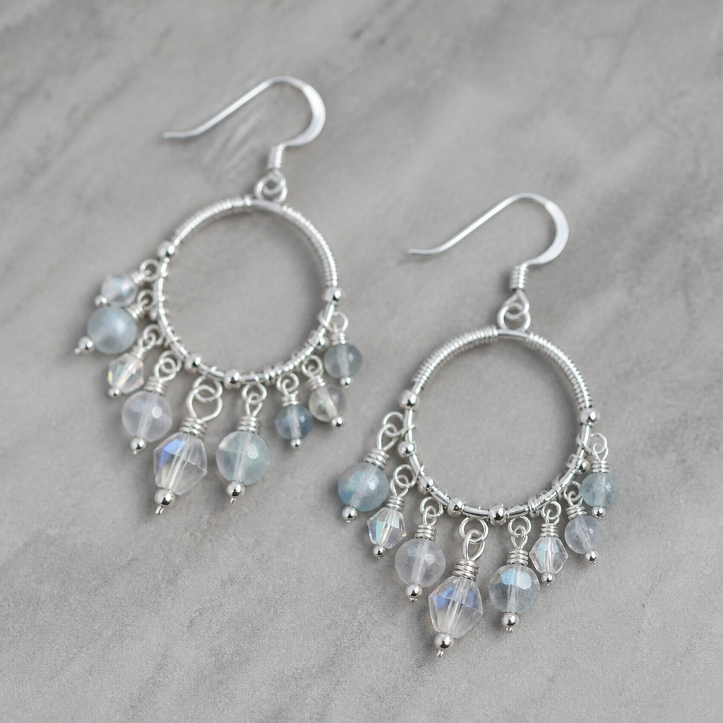 A women's earrings made of silver suitable for daily wear. a bohemian style bead and crystal bead and wire set of hoop or dangle earrings
photorealistic jewelry design, A women's earrings made of silver suitable for daily wear. a bohemian style bead and crystal bead and wire set of hoop or dangle earrings, modern style, just the design no text