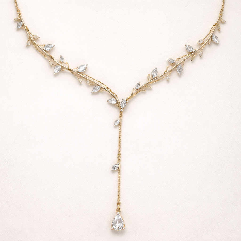 Thin Gold chain with thin wire wrapped around it like an olive branch and small pear cut diamond stones placed throughout the chain with a lariat.