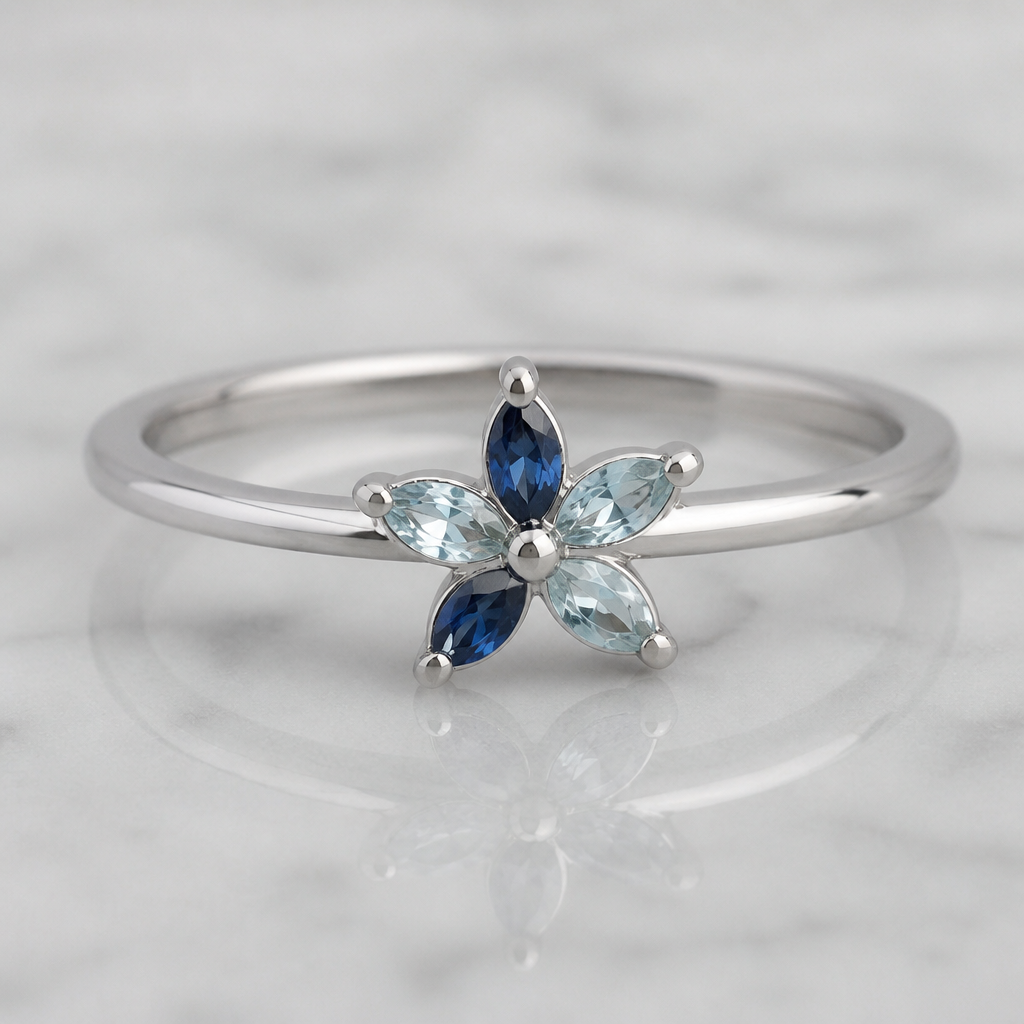 A minimalist women's ring made of platinum with sapphire and aquamarine stones. a simplistic ring with a delicate floral design
photorealistic jewelry design, A minimalist women's ring made of platinum with sapphire and aquamarine stones. a simplistic ring with a delicate floral design, minimalist style, just the design no text