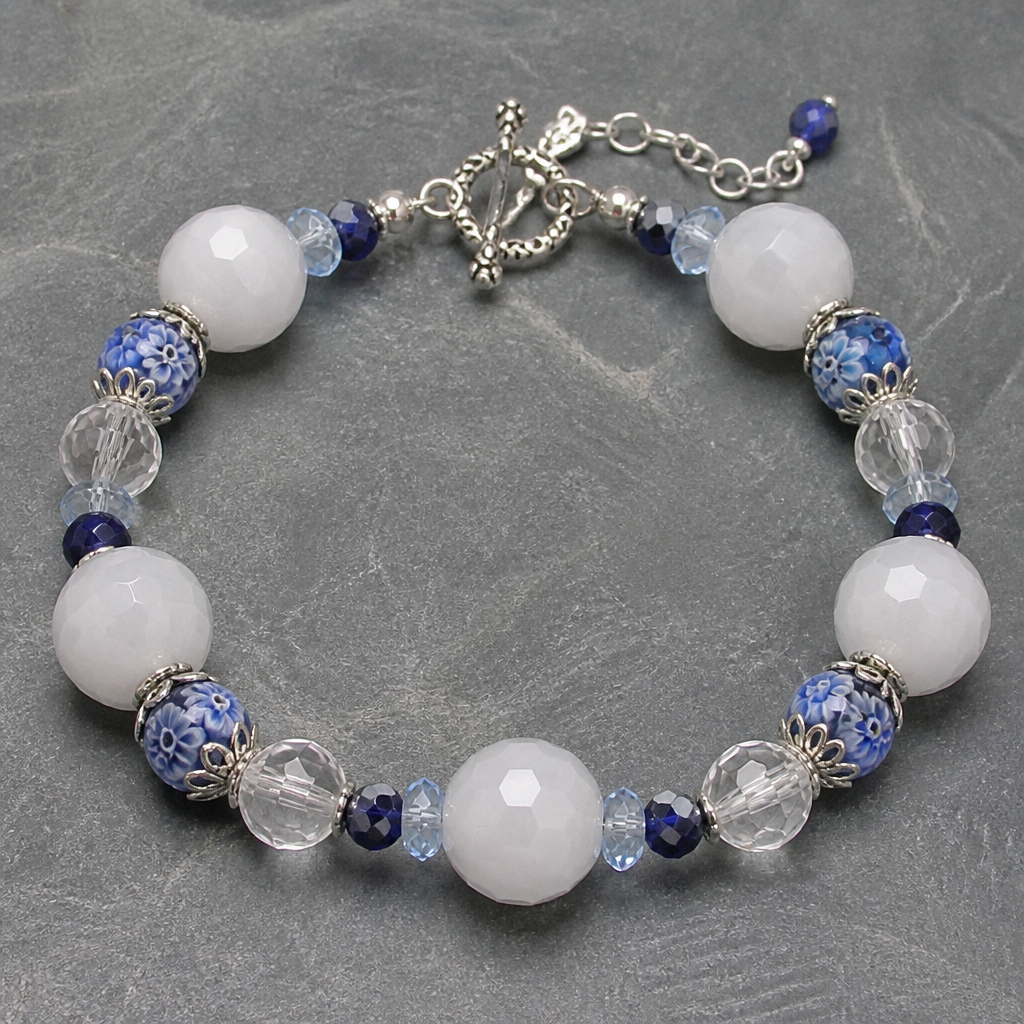 "White faceted jade beads 12mm, clear faceted crystal quartz 10mm, sapphire rough cut round beads 6mm, millefiori blue with light blue flowers 8mm, light faintly blue faceted crystals 6mm, silver findings
Save
photorealistic jewelry design, "White faceted jade beads 12mm, clear faceted crystal quartz 10mm, sapphire rough cut round beads 6mm, millefiori blue with light blue flowers 8mm, light faintly blue faceted crystals 6mm, silver findings
Save, bohemian style, just the design no text