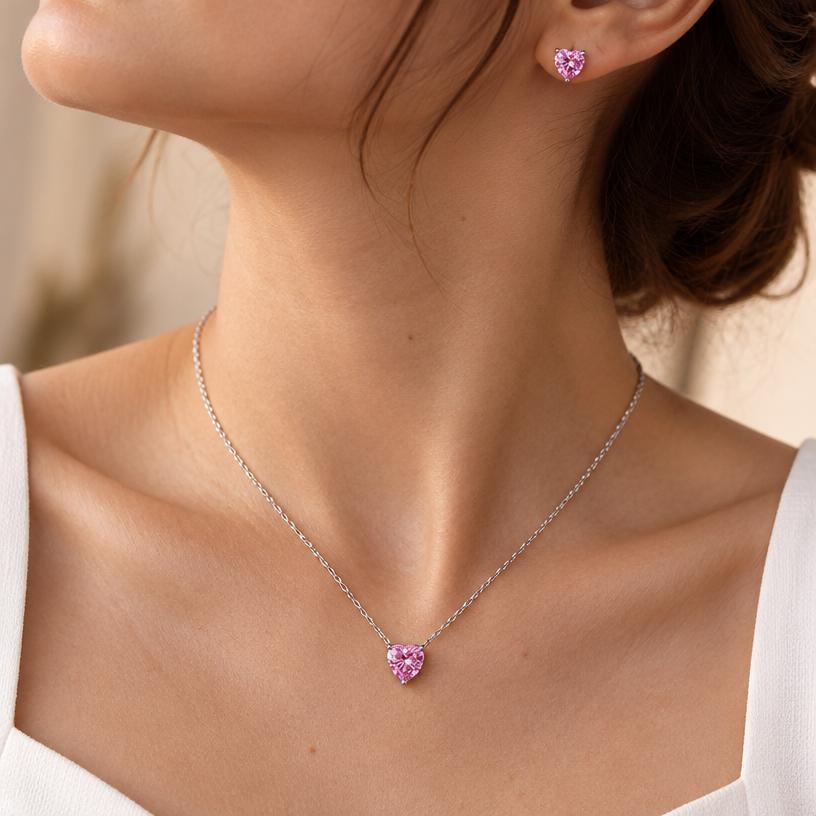 Jewelry photoshoot (worn)
Show the jewelry piece from the image worn by an elegant model in a professional editorial photograph, soft studio lighting. Reproduce the jewelry's exact design, metal, stones and details faithfully. Photorealistic, no text. Additional instructions: "Close-up editorial jewelry photo of a woman's neck, collarbone, and upper chest, cropped so the face is fully out of frame (only neck, collarbone, and chest visible). She wears a plain white top and a delicate sterling silver necklace with a clear heart-shaped cubic zirconia pendant, set in a simple four-prong setting.
METAL FINISH: the sterling silver must be rhodium-plated — bright, cool-white, and reflective with a polished mirror-like shine, not dull or matte. The metal should catch light naturally, without looking overly glossy, plastic, or artificially glowing.
STONE DETAIL: the clear heart-cut cubic zirconia stone must be sparkling and perfectly faceted with a clean heart shape, catching light realistically with natural brilliance — not flat or dull.
SKIN REALISM REQUIREMENT: skin must look completely natural and photorealistic — visible fine skin texture, natural pores, subtle imperfections, soft even tone. Avoid any smooth, plastic, airbrushed, CGI, or overly retouched look. Lighting soft and warm, casting natural gentle shadows.
STRICT SIZE REQUIREMENT: the pendant must be exactly 0.7cm height x 0.7cm width, true to real-life scale against the neck and collarbone — do not enlarge or oversize.
CHAIN AND PENDANT POSITION: fine cable chain draping naturally in a soft V-shape along the collarbone, with the heart pendant hanging centered at the lowest point of the chain, point of the heart facing down, attached by a small prong setting at the top.
"Close-up editorial jewelry photo of a woman's neck, collarbone, and upper chest, cropped so the face is fully out of frame (only neck, collarbone, ear, and chest visible). She wears a delicate sterling silver necklace with a clear heart-shaped cubic zirconia pendant and a matching heart-shaped cubic zirconia stud earring, both set in a simple four-prong setting.
METAL FINISH: the sterling silver must be rhodium-plated — bright, cool-white, and reflective with a polished mirror-like shine, not dull or matte. The metal should catch light naturally, without looking overly glossy, plastic, or artificially glowing.
STONE DETAIL: the clear heart-cut cubic zirconia stones must be sparkling and perfectly faceted with a clean heart shape, catching light realistically with natural brilliance — not flat or dull.
SKIN REALISM REQUIREMENT: skin must look completely natural and photorealistic — visible fine skin texture, natural pores, subtle imperfections, soft even tone. Avoid any smooth, plastic, airbrushed, CGI, or overly retouched look. Lighting soft and warm, casting natural gentle shadows.
STRICT SIZE REQUIREMENT: the pendant and earring must be small and delicate, true to real-life scale against the neck and ear — do not enlarge or oversize.
CHAIN AND PENDANT POSITION: fine cable chain draping naturally in a soft V-shape along the collarbone, with the heart pendant hanging centered at the lowest point of the chain, point of the heart facing down, attached by a small prong setting at the top. Earring sits naturally on the earlobe, heart pointing down.
"Close-up editorial jewelry photo of a woman's neck, collarbone, ear, and upper chest, cropped so the face is fully out of frame (only neck, collarbone, ear, and chest visible, head gently turned to reveal the ear). She wears a delicate sterling silver necklace with a clear heart-shaped cubic zirconia pendant and a matching heart-shaped cubic zirconia stud earring, both set in a simple four-prong setting.
METAL FINISH: the sterling silver must be rhodium-plated — bright, cool-white, and reflective with a polished mirror-like shine, not dull or matte. The metal should catch light naturally, without looking overly glossy, plastic, or artificially glowing.
STONE DETAIL: the clear heart-cut cubic zirconia stones must be sparkling and perfectly faceted with a clean heart shape, catching light realistically with natural brilliance — not flat or dull.
SKIN REALISM REQUIREMENT: skin must look completely natural and photorealistic — visible fine skin texture, natural pores, subtle imperfections, soft even tone. Avoid any smooth, plastic, airbrushed, CGI, or overly retouched look. Lighting soft and warm, casting natural gentle shadows.
STRICT SIZE REQUIREMENT: both pieces must be small and delicate, true to real-life scale — the necklace pendant slightly larger than the earring (matching the reference proportions), both clearly visible and sharply in focus, correctly positioned relative to the neck and ear. Do not enlarge, oversize, or distort either piece.
CHAIN AND PENDANT POSITION: fine cable chain draping naturally in a soft V-shape along the collarbone, with the heart pendant hanging centered at the lowest point of the chain, point of the heart facing down, attached by a small prong setting at the top. The stud earring sits naturally and securely on the earlobe, heart pointing down, fully visible and in focus alongside the necklace.
Close-up editorial jewelry photo of a woman's neck, collarbone, ear, and upper chest, cropped so the face is fully out of frame. Head tilted slightly upward and turned to the opposite side compared to a typical straight-on shot, exposing the neck at a different angle, hair swept back or gathered to one side to keep the ear and collarbone fully visible. Shoulders relaxed, one shoulder slightly raised for a more dynamic, natural pose.
She wears a delicate sterling silver necklace with a heart-shaped pink cubic zirconia pendant and a matching heart-shaped pink cubic zirconia stud earring, both set in a simple four-prong setting.
METAL FINISH: the sterling silver must be rhodium-plated — bright, cool-white, and reflective with a polished mirror-like shine, not dull or matte. The metal should catch light naturally, without looking overly glossy, plastic, or artificially glowing.
STONE COLOR AND DETAIL: the heart-cut cubic zirconia stones must be a vivid, true pink color (not red, not purple, not pale/washed out) — matching a bright candy-pink tone exactly. The stones must be sparkling and perfectly faceted with a clean heart shape, catching light realistically with natural brilliance.
SKIN REALISM REQUIREMENT: skin must look completely natural and photorealistic — visible fine skin texture, natural pores, subtle imperfections, soft even tone. Avoid any smooth, plastic, airbrushed, CGI, or overly retouched look. Lighting soft and warm, casting natural gentle shadows.
STRICT SIZE REQUIREMENT: the pendant must be exactly 0.7cm height, and the earring exactly 0.6cm height, true to real-life scale against the neck and ear — the pendant slightly larger than the earring, matching real proportions exactly. Do not enlarge, oversize, or distort either piece.
CHAIN AND PENDANT POSITION: fine cable chain draping naturally in a soft V-shape along the collarbone, with the heart pendant hanging centered at the lowest point of the chain, point of the heart facing down, attached by a small prong setting at the top. The stud earring sits naturally and securely on the earlobe, heart pointing down, fully visible and in focus alongside the necklace.
Background softly blurred, warm and neutral, shallow depth of field. Mood: elegant, minimal, intimate — natural high-end jewelry brand photography style, face not shown, both necklace and earring clearly and accurately rendered in true color and correct scale."
METAL FINISH: the sterling silver must be rhodium-plated — bright, cool-white, and reflective with a polished mirror-like shine, not dull or matte. The metal should catch light naturally, without looking overly glossy, plastic, or artificially glowing.
STONE COLOR AND DETAIL: the heart-cut cubic zirconia stones must be a vivid, true pink color (not red, not purple, not pale/washed out) — matching a bright candy-pink tone exactly. The stones must be sparkling and perfectly faceted with a clean heart shape, catching light realistically with natural brilliance.
SKIN REALISM REQUIREMENT: skin must look completely natural and photorealistic — visible fine skin texture, natural pores, subtle imperfections, soft even tone. Avoid any smooth, plastic, airbrushed, CGI, or overly retouched look. Lighting soft and warm, casting natural gentle shadows.
STRICT SIZE REQUIREMENT: the pendant must be exactly 0.7cm height, and the earring exactly 0.6cm height, true to real-life scale against the neck and ear — the pendant slightly larger than the earring, matching real proportions exactly. Do not enlarge, oversize, or distort either piece.
CHAIN AND PENDANT POSITION: fine cable chain draping naturally in a soft V-shape along the collarbone, with the heart pendant hanging centered at the lowest point of the chain, point of the heart facing down, attached by a small prong setting at the top. The stud earring sits naturally and securely on the earlobe, heart pointing down, fully visible and in focus alongside the necklace.
Background softly blurred, warm and neutral, shallow depth of field. Mood: elegant, minimal, intimate — natural high-end jewelry brand photography style, face not shown, both necklace and earring clearly and accurately rendered in true color and correct scale..
