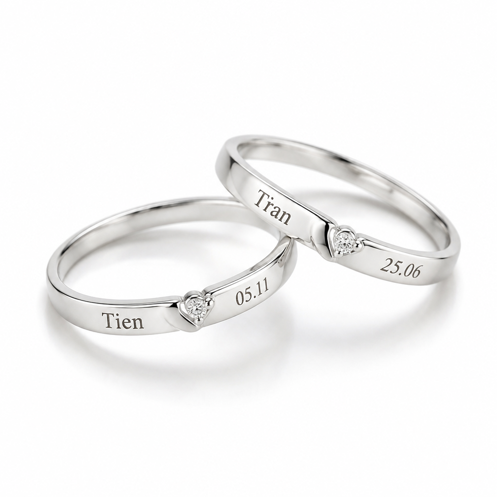 Create a matching pair of minimalist women's rings made of 925 sterling silver. Elegant, delicate, modern Korean style. One ring engraved with the name "Tien" and the date "05.11", the other engraved with the name "Tran" and the date "25.06". Slim bands, smooth polished silver finish, subtle romantic details, comfortable everyday wear. Display both rings together on a clean white background, realistic jewelry product photography.
photorealistic jewelry design, Create a matching pair of minimalist women's rings made of 925 sterling silver. Elegant, delicate, modern Korean style. One ring engraved with the name "Tien" and the date "05.11", the other engraved with the name "Tran" and the date "25.06". Slim bands, smooth polished silver finish, subtle romantic details, comfortable everyday wear. Display both rings together on a clean white background, realistic jewelry product photography., modern style, just the design no text