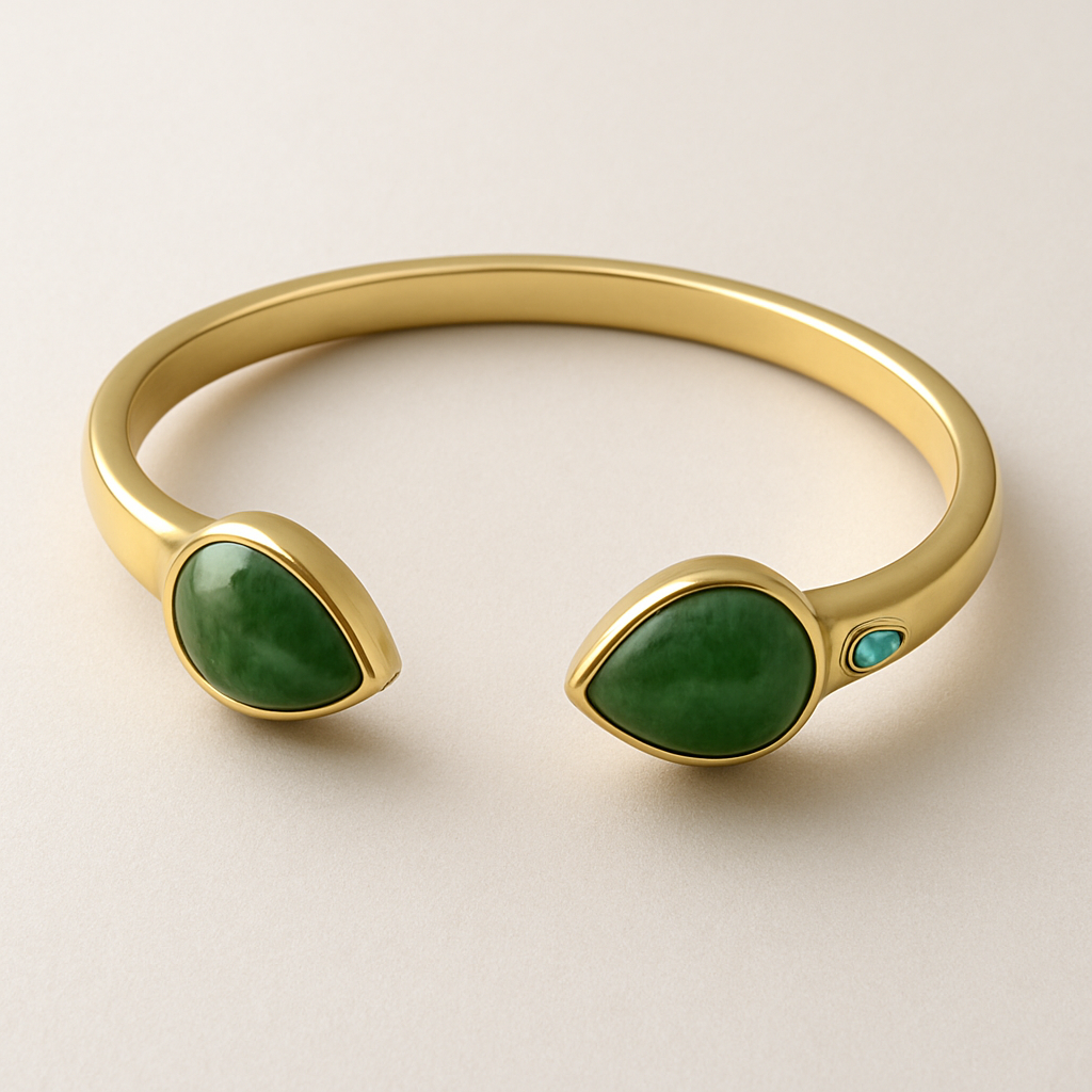 Create a yellow gold cuff with two pear shaped pieces of nephrite jade at the ends and two petite pear shaped blue topaz’s set in the gold of the bracelet