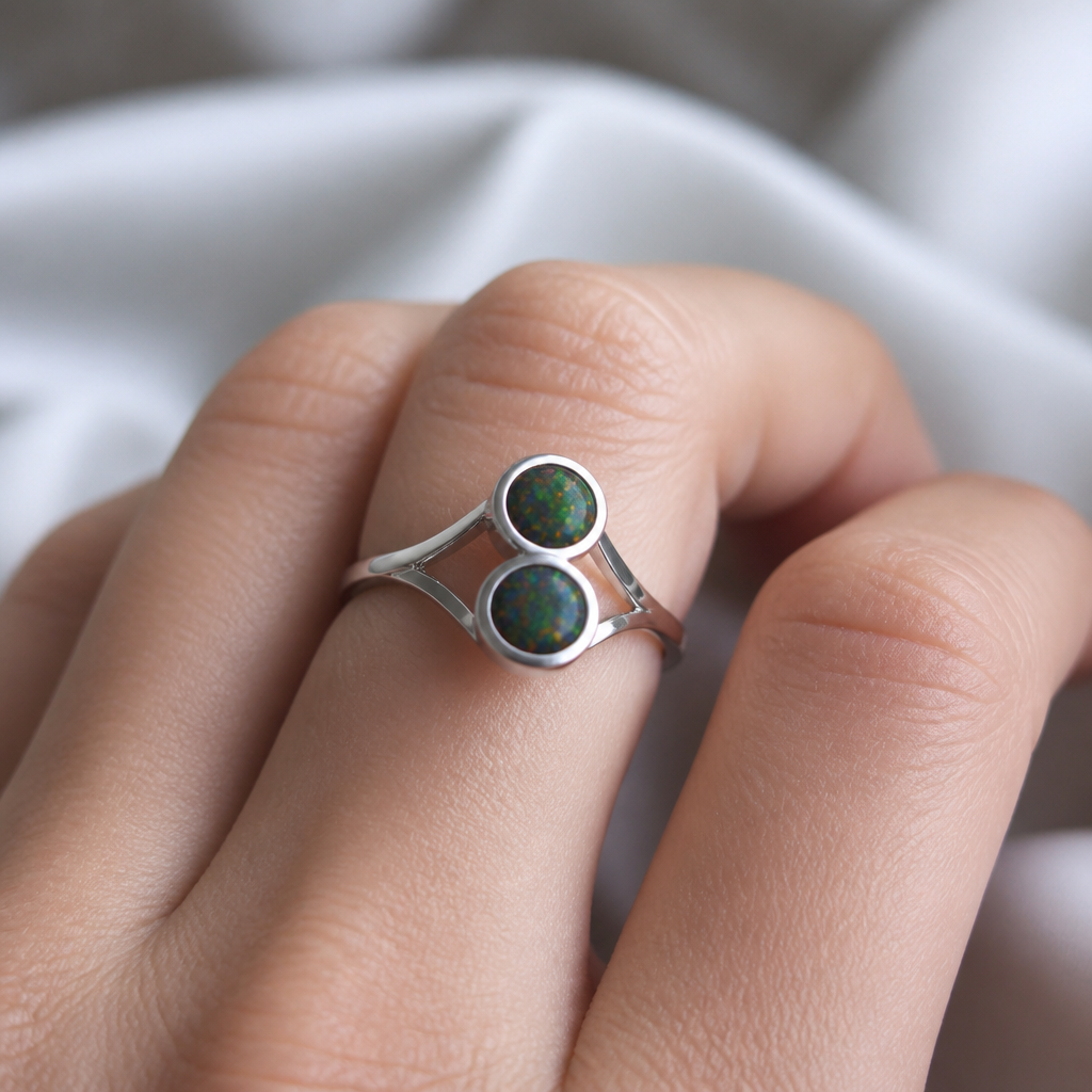 A modern women's ring made of silver suitable for daily wear, ultra-minimalist, very simple and clean, understated, no embellishments. I want two black opals about 8mm one on top of the other and a simple design on the side
photorealistic jewelry design, A modern women's ring made of silver suitable for daily wear, ultra-minimalist, very simple and clean, understated, no embellishments. I want two black opals about 8mm one on top of the other and a simple design on the side, modern style, just the design no text