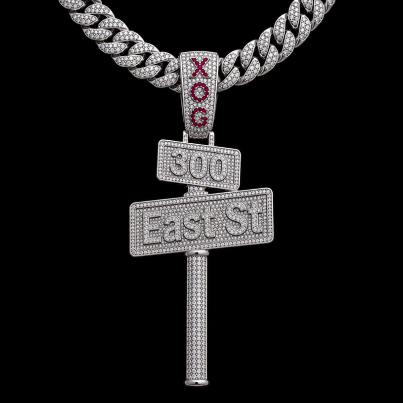 make a silver diamond pendent of a street sign the bottom sign say East St with a pole coming out the bottom coming down 2 inch’s and the top sign say 300 and put it on a silver cuban link chain and on the bail connecting the pendent to the chain make it say XOG with red rubys
edit the attached jewelry design with these instructions: make a silver diamond pendent of a street sign the bottom sign say East St with a pole coming out the bottom coming down 2 inch’s and the top sign say 300 and put it on a silver cuban link chain and on the bail connecting the pendent to the chain make it say XOG with red rubys. keep it photorealistic, just the design no text