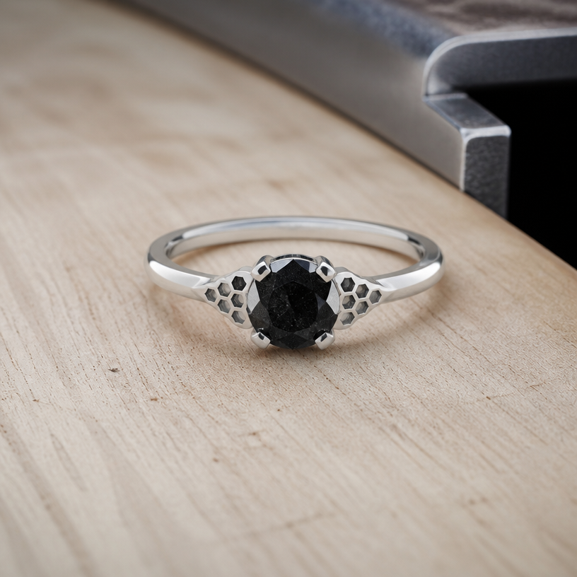 A women's ring made of silver, ultra-minimalist, very simple and clean, understated, no embellishments. take this black onyx and make some honeycomb outside the stone on either side
using the attached image as a visual reference, create A women's ring made of silver, ultra-minimalist, very simple and clean, understated, no embellishments. take this black onyx and make some honeycomb outside the stone on either side. photorealistic, just the design no text