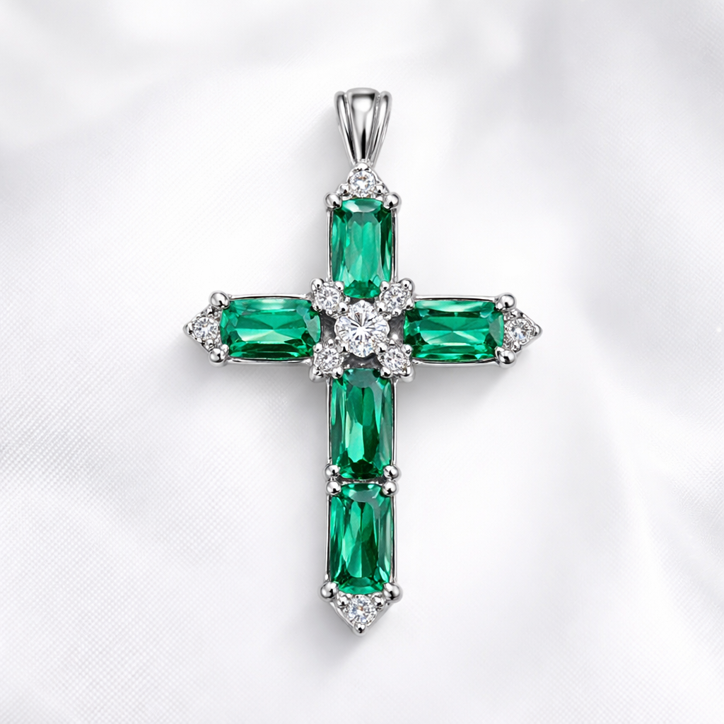 Emerald white gold cross and with simple diamond accent stones. Timeless, elegant, and classy. Hidden bail. Light metal work.