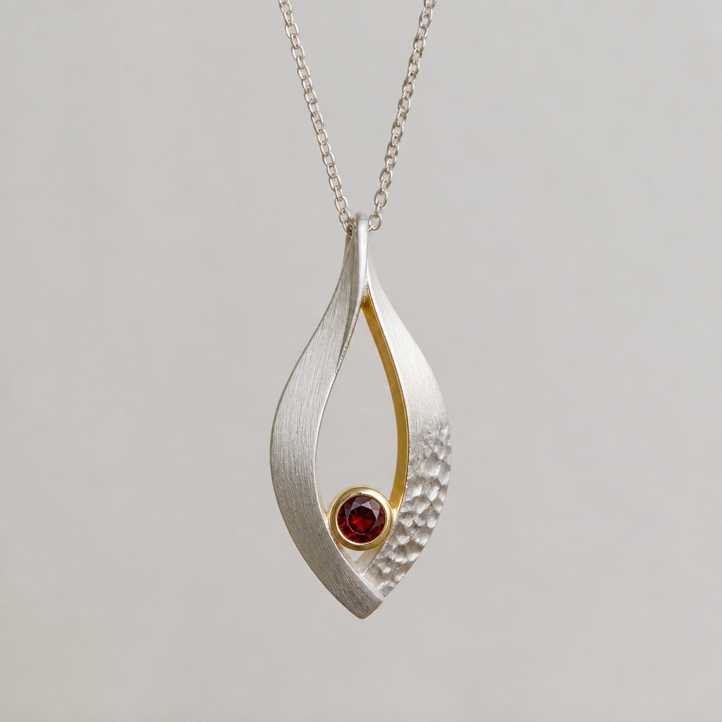 A scandinavian women's pendant made of silver with garnet stones suitable for daily wear, minimalist, simple and delicate, clean lines. simplistic form minimalist brushed silver finish with and accent of gold and a small section of hammered surface
photorealistic jewelry design, A scandinavian women's pendant made of silver with garnet stones suitable for daily wear, minimalist, simple and delicate, clean lines. simplistic form minimalist brushed silver finish with and accent of gold and a small section of hammered surface, scandinavian style, just the design no text