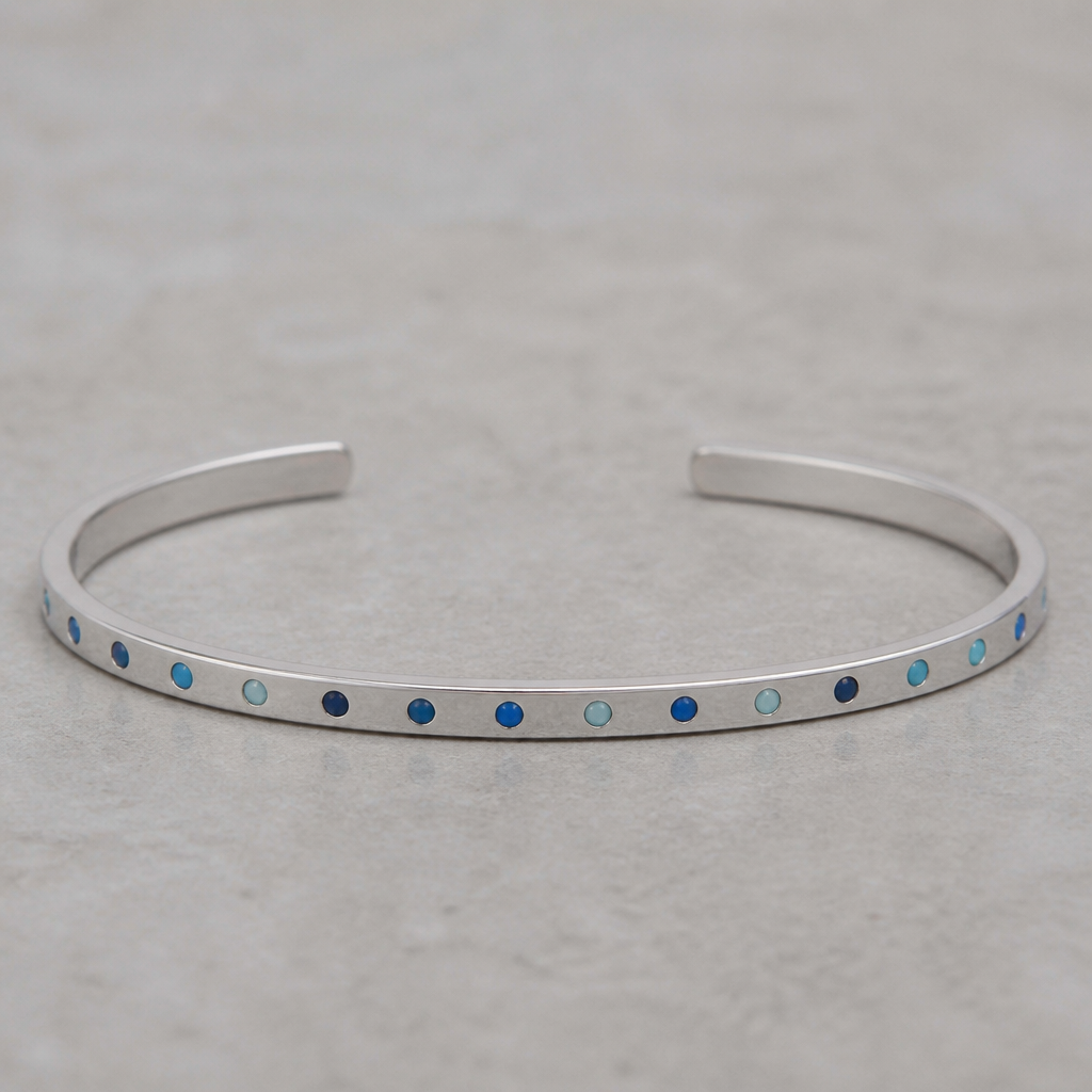 A women's bracelet made of silver. 2mm*4mm cuff with engraved dots every dot is colored with eneamel colors navy, blue, and baby blue
photorealistic jewelry design, A women's bracelet made of silver. 2mm*4mm cuff with engraved dots every dot is colored with eneamel colors navy, blue, and baby blue, modern style, just the design no text