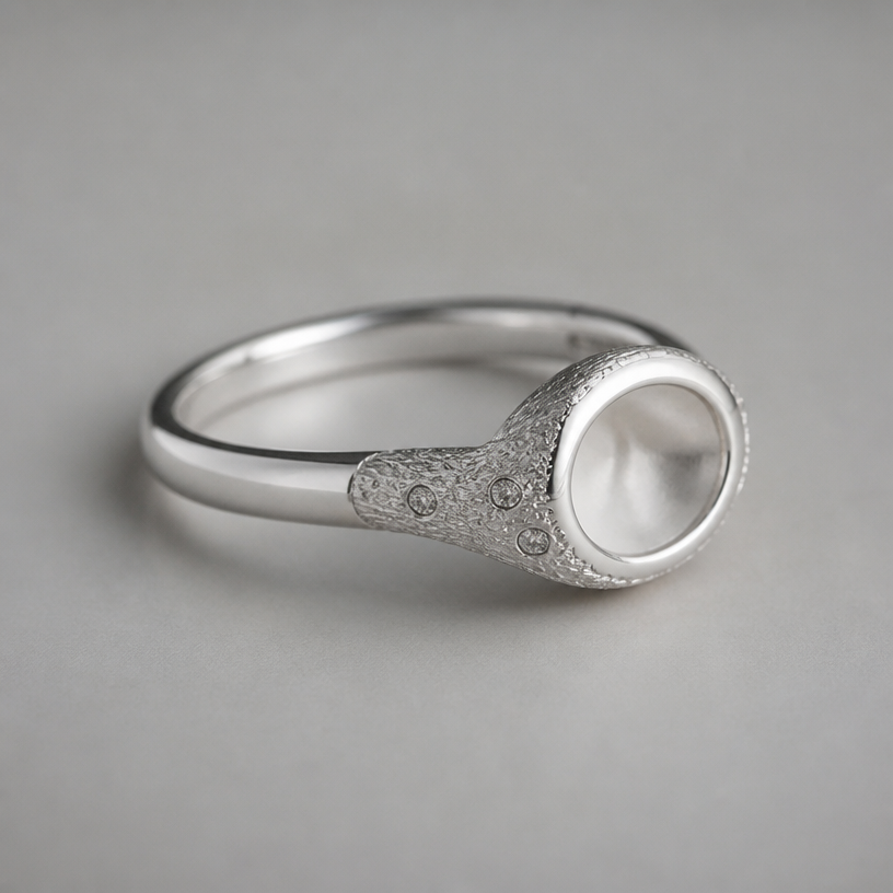 A nature women's ring made of silver. не большое кольцо, минималистичное, акцент на разнице текстур. часть гладкая, часть текстурная. модно насколько мелких камней
using the attached image as a visual reference, create A nature women's ring made of silver. не большое кольцо, минималистичное, акцент на разнице текстур. часть гладкая, часть текстурная. модно насколько мелких камней. photorealistic, just the design no text