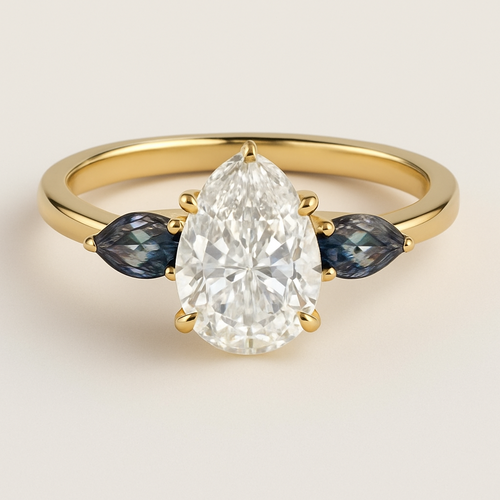 2 carat pear cut diamond engagement ring with double claw prongs in yellow gold ring with marquise shaped alexandrite side stones 