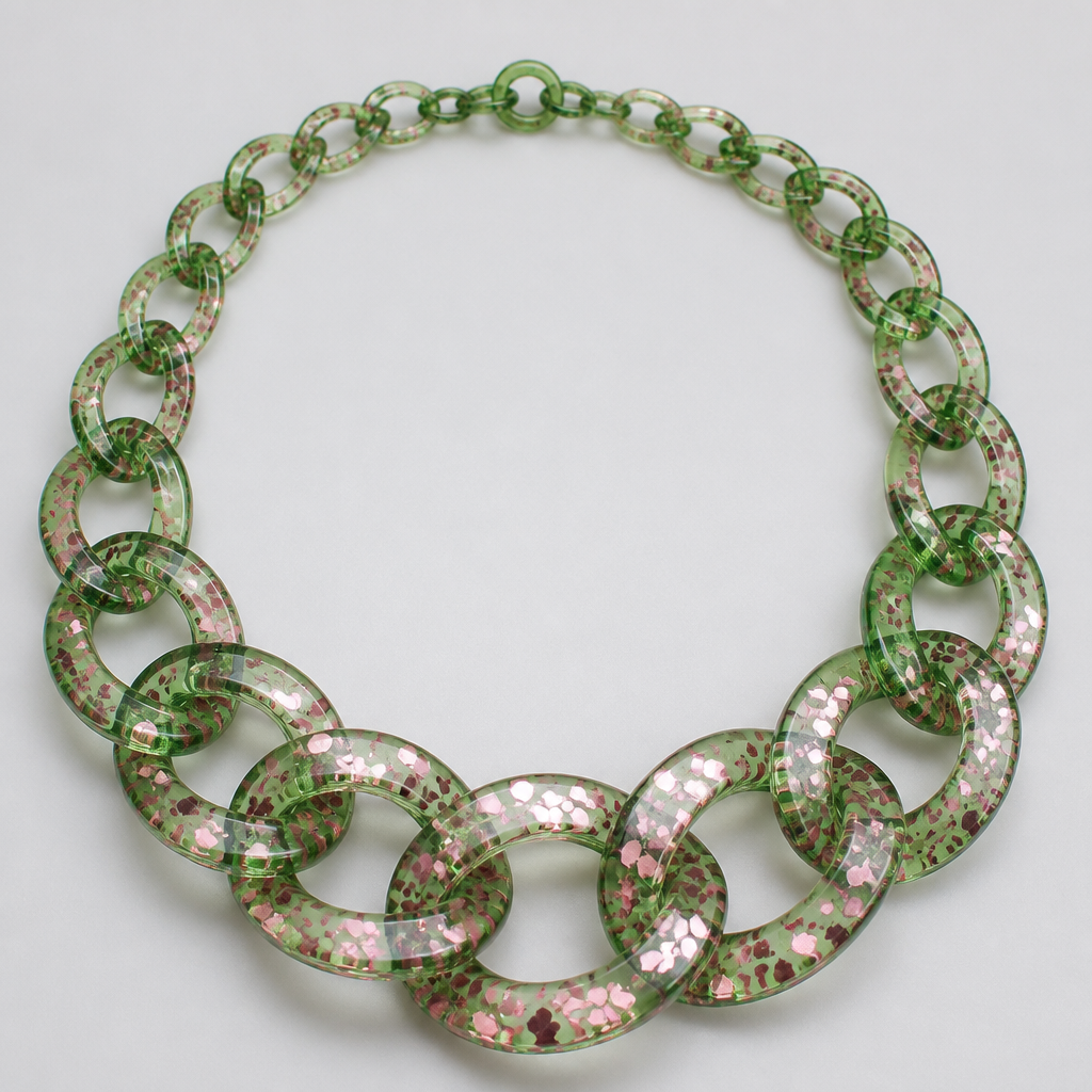 A women's ring. Please make me a jewelry image of a chunky graduated necklace chain in translucent green plastic with pink metallic confetti inside
photorealistic jewelry design, A women's ring. Please make me a jewelry image of a chunky graduated necklace chain in translucent green plastic with pink metallic confetti inside, modern style, just the design no text