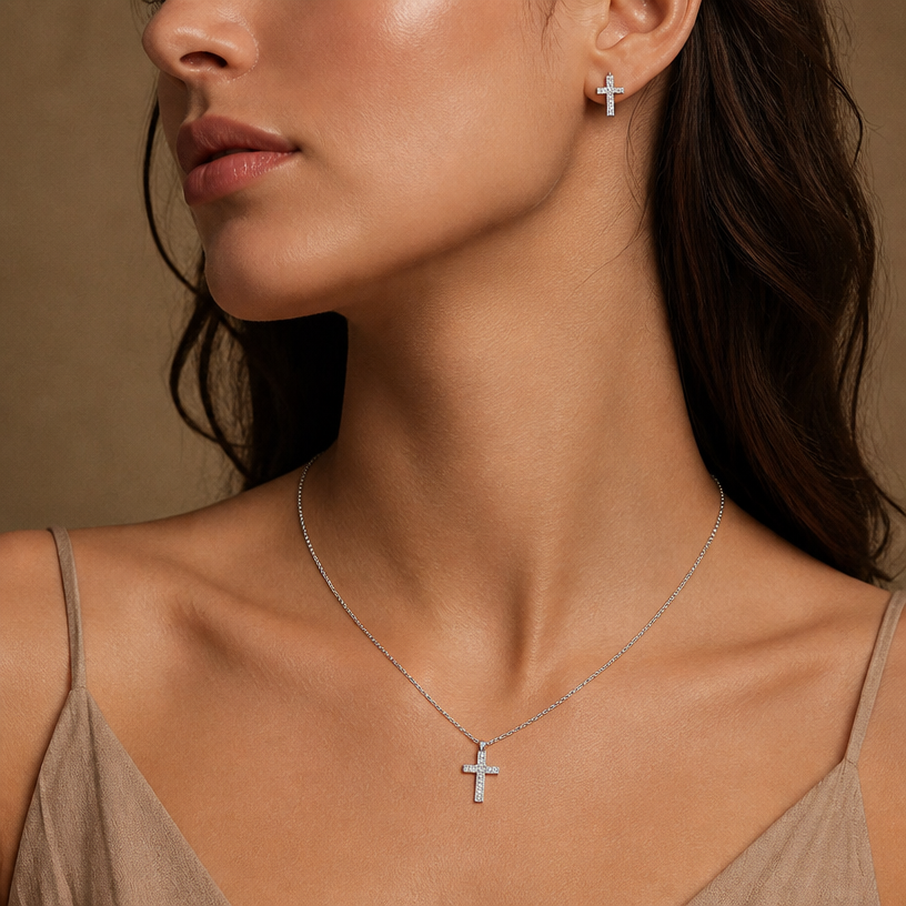 Jewelry photoshoot (worn)
Show the jewelry piece from the image worn by an elegant model in a professional editorial photograph, soft studio lighting. Reproduce the jewelry's exact design, metal, stones and details faithfully. Photorealistic, no text. Additional instructions: A professional portrait photograph of a model with minimalist, warm-toned aesthetic matching the "lunera.am" look. Focus on the neck and ear areas. The model is wearing a true-to-size rhodium-plated 925 sterling silver cross pendant necklace on a delicate 41cm chain with 5cm extension, and matching silver cross stud earrings (each approximately 1cm tall). The silver is bright and white due to the rhodium plating, and the pave diamonds sparkle. Soft, even studio lighting. Highly detailed textures of skin and jewelry. Clean background..
