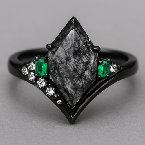 Kite cut Black rutilated quartz with 1 emerald on each side and 3 moissanite on each side accent stones in a cluster on a black band, second band black with moissanite stones that curves around the main stone 
