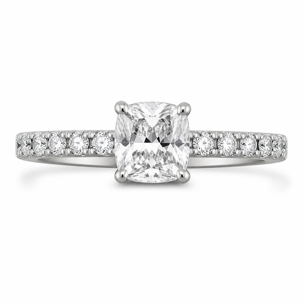 8x6mm cushion cut diamond
White gold
Smalls on the band, 4 claws per stone
Cat claws
photorealistic jewelry design, just the design, no text, 8x6mm cushion cut diamond in a white gold band, with small round diamonds set along the band, and four claw prongs securing each gemstone.