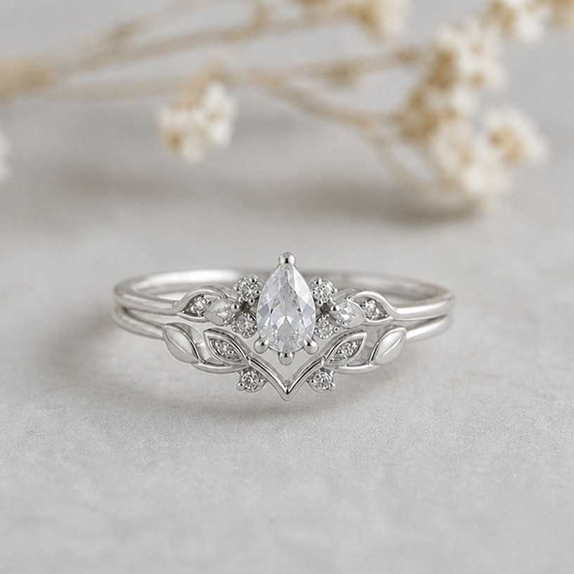 Please adjust the position of the mainstone so it doesn‘t leave as much space between main stone and v form of the second ring
edit the attached jewelry design with these instructions: Please adjust the position of the mainstone so it doesn‘t leave as much space between main stone and v form of the second ring. keep it photorealistic, just the design no text