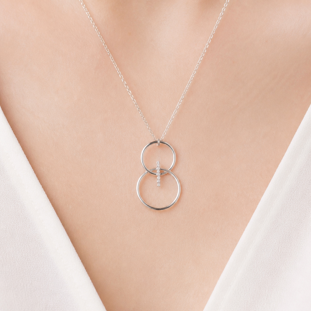 A women's pendant made of silver. collier avec 2 cercles fin, un par dessus l'autre,sans diamand, cercle du dessus plus petit, relié par une ligne de diamands qui est dans les cercles, cercles superposé haut en bas, design petit
photorealistic jewelry design, A women's pendant made of silver. collier avec 2 cercles fin, un par dessus l'autre,sans diamand, cercle du dessus plus petit, relié par une ligne de diamands qui est dans les cercles, cercles superposé haut en bas, design petit, modern style, just the design no text