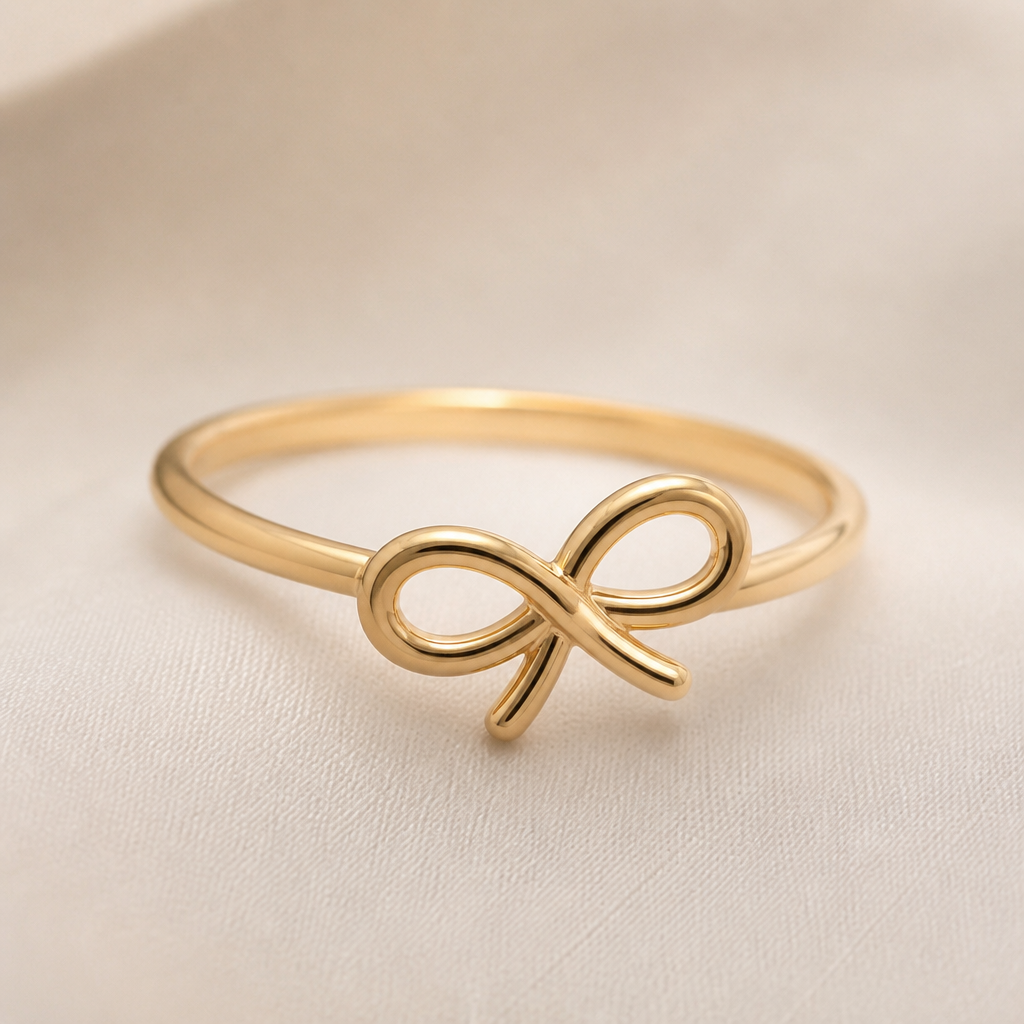 A minimalist women's ring made of gold suitable for gift. the ribbon design that tilted a little bit to the right and the ribbon design is very simple not to crowded design . between the loops inside the ribbon is empty. the ring is go around the ribbon not on top of the ring. the ribbon is more round and the tail of the ribbon is a little bit short
photorealistic jewelry design, A minimalist women's ring made of gold suitable for gift. the ribbon design that tilted a little bit to the right and the ribbon design is very simple not to crowded design . between the loops inside the ribbon is empty. the ring is go around the ribbon not on top of the ring. the ribbon is more round and the tail of the ribbon is a little bit short, minimalist style, just the design no text