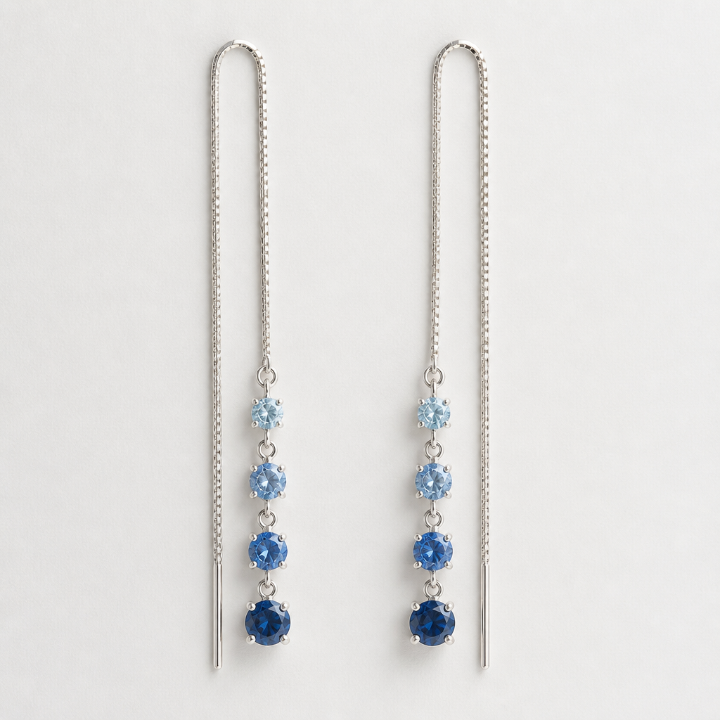 Silver threader earrings. Four different color blue stones hanging off the front side. All stones are oval or round. The lowest stone is the biggest but still not more than 2mm wide and they get smaller as they ascend up. The back end of the threaded on the other side is a little thicker silver like still less than a mm. Stones are prongs not bezel.
photorealistic jewelry design, Silver threader earrings. Four different color blue stones hanging off the front side. All stones are oval or round. The lowest stone is the biggest but still not more than 2mm wide and they get smaller as they ascend up. The back end of the threaded on the other side is a little thicker silver like still less than a mm. Stones are prongs not bezel. , minimalist style, just the design no text