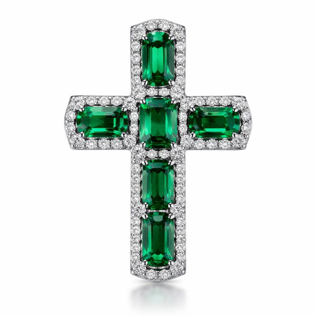 Emerald white gold cross and with simple diamond accent stones. Timeless, elegant, and classy. Hidden bail.