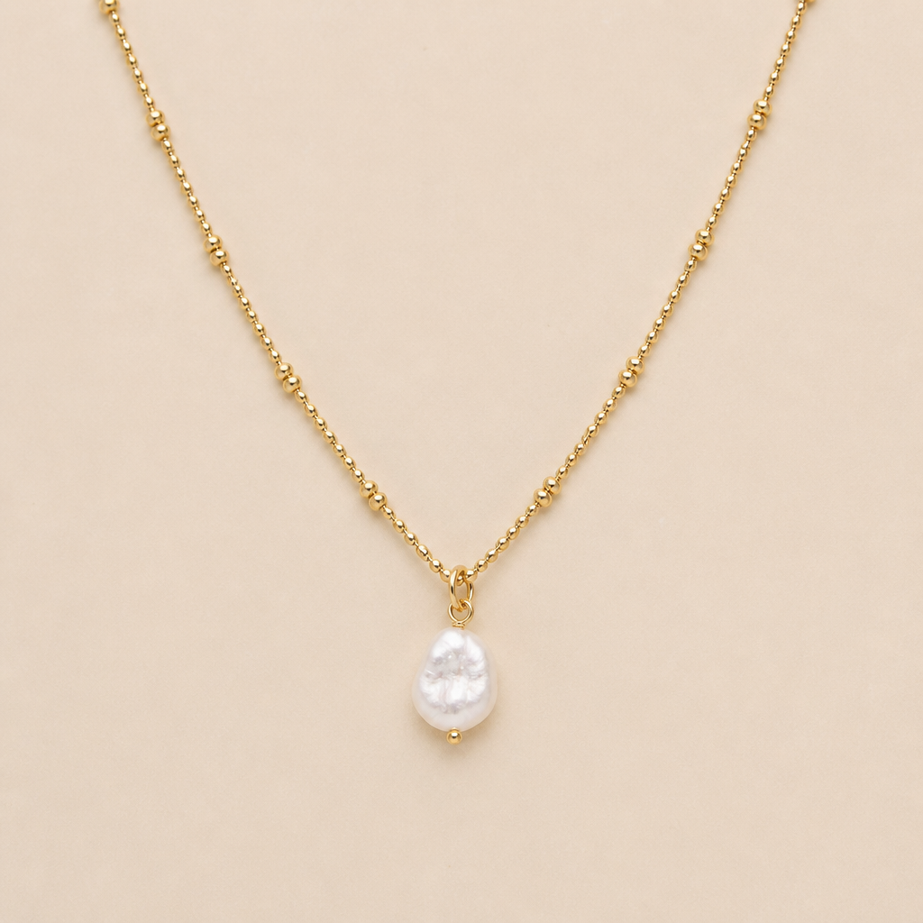 Dainty beaded necklace gold plated with irregular pearl pendant
photorealistic jewelry design, Dainty beaded necklace gold plated with irregular pearl pendant , minimalist style, just the design no text