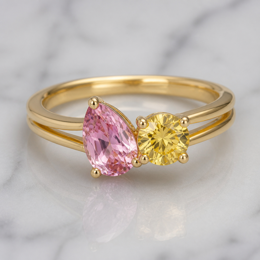 A classic women's ring with sapphire stones suitable for birthday. anello toi e moi con zaffiro rosa taglio goccia e affianco zaffiro giallo rotondo di dimensioni uguali medie montato su oro giallo con gambo più doppio alla base e più stretto verso le pietre
photorealistic jewelry design, A classic women's ring with sapphire stones suitable for birthday. anello toi e moi con zaffiro rosa taglio goccia e affianco zaffiro giallo rotondo di dimensioni uguali medie montato su oro giallo con gambo più doppio alla base e più stretto verso le pietre, classic style, just the design no text