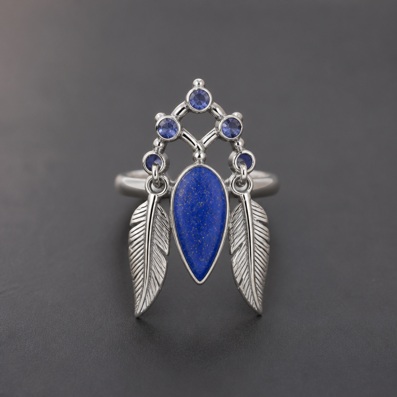 A women's ring with sapphire stones. lapis gemstone pendant two feathers on the side
using the attached image as a visual reference, create A women's ring with sapphire stones. lapis gemstone pendant two feathers on the side. photorealistic, just the design no text