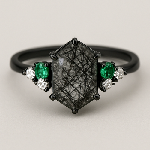 Skinny medium length Hexagon cut Black rutilated quartz with 1 emerald on each side and 3 moissanite on each side accent stones in a cluster on a black band
