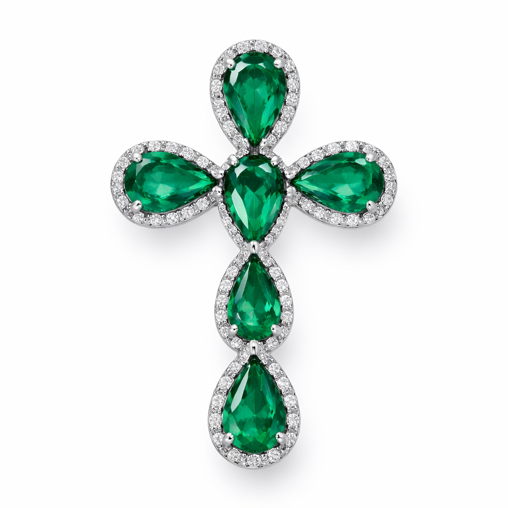 Pear cut emerald cross on 14k white gold with bale attached to the back and not shown. Few diamond accent stones. Classic, simple, and elegant