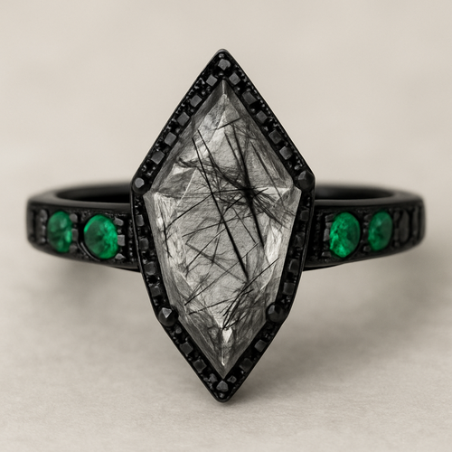 Black band, kite cut tourmalated quartz, emerald accent stones 3 on each side, second band black going around the kite stone with black stones