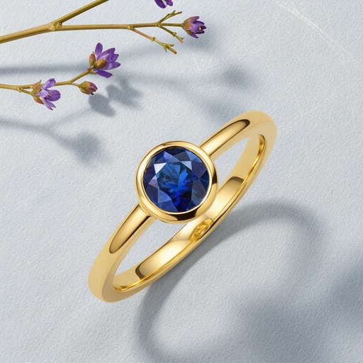 Gold ring with a round blue Sapphire set in claw setting