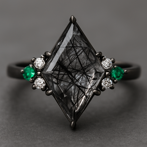 Kite cut Black rutilated quartz with 1 emerald on each side and 3 moissanite on each side accent stones in a cluster on a black band