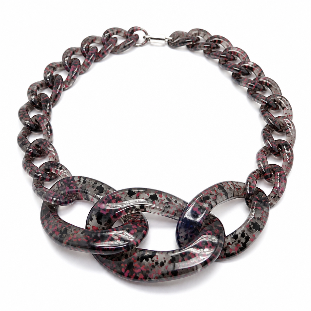A women's necklace. create a chunky Cuban Link style plastic chain that is o graduated and exaggerated in the first front three links that is translucent confetti lucite of dark grel and pink
photorealistic jewelry design, A women's necklace. create a chunky Cuban Link style plastic chain that is o graduated and exaggerated in the first front three links that is translucent confetti lucite of dark grel and pink, modern style, just the design no text