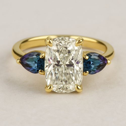 2 carat elongated cushion cut diamond engagement ring with double claw prongs in yellow gold ring with marquise shaped alexandrite side stones 