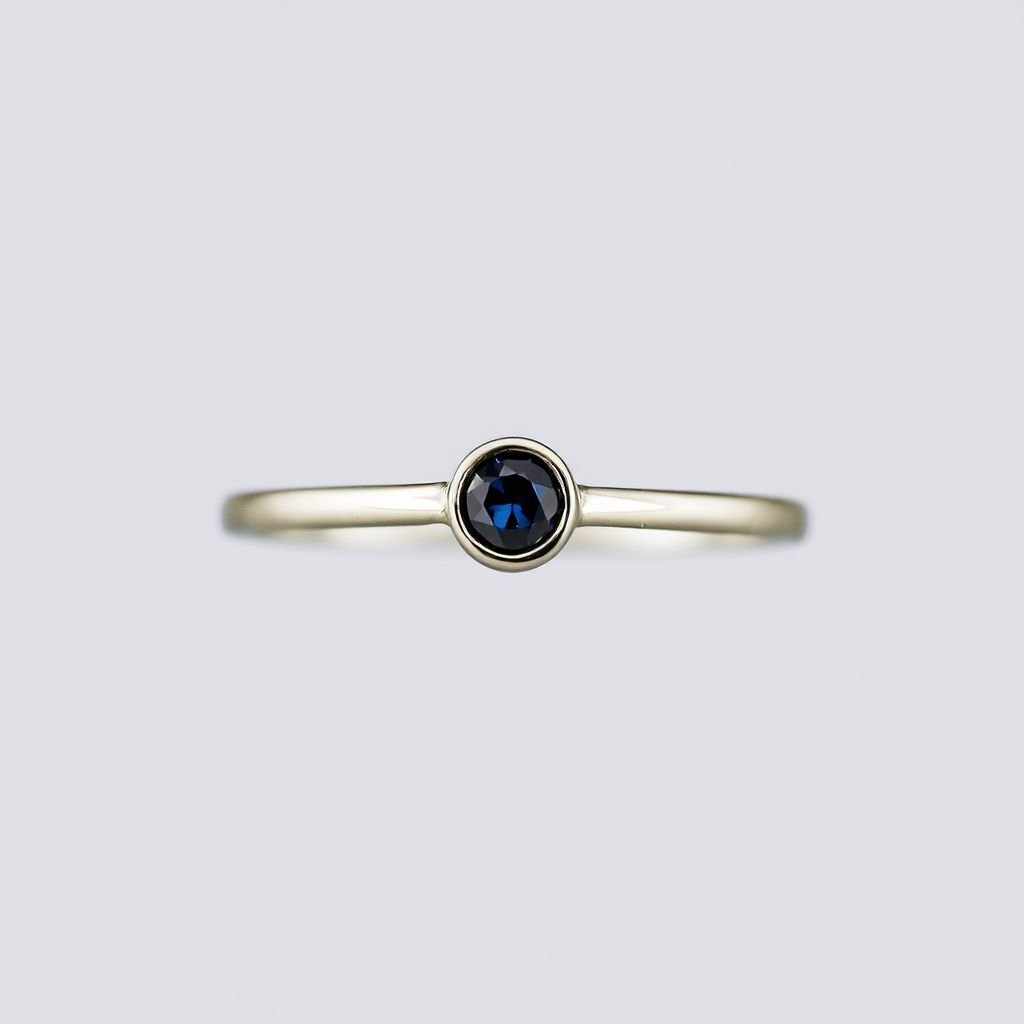 Tiny bezel set single sapphire in the middle of the index finger, nail jewlery