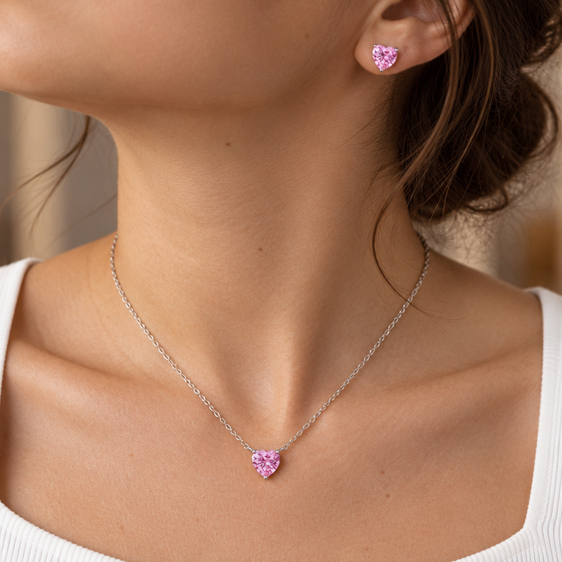 Jewelry photoshoot (worn)
Show the jewelry piece from the image worn by an elegant model in a professional editorial photograph, soft studio lighting. Reproduce the jewelry's exact design, metal, stones and details faithfully. Photorealistic, no text. Additional instructions: "Close-up editorial jewelry photo of a woman's neck, collarbone, and upper chest, cropped so the face is fully out of frame (only neck, collarbone, and chest visible). She wears a plain white top and a delicate sterling silver necklace with a clear heart-shaped cubic zirconia pendant, set in a simple four-prong setting.
METAL FINISH: the sterling silver must be rhodium-plated — bright, cool-white, and reflective with a polished mirror-like shine, not dull or matte. The metal should catch light naturally, without looking overly glossy, plastic, or artificially glowing.
STONE DETAIL: the clear heart-cut cubic zirconia stone must be sparkling and perfectly faceted with a clean heart shape, catching light realistically with natural brilliance — not flat or dull.
SKIN REALISM REQUIREMENT: skin must look completely natural and photorealistic — visible fine skin texture, natural pores, subtle imperfections, soft even tone. Avoid any smooth, plastic, airbrushed, CGI, or overly retouched look. Lighting soft and warm, casting natural gentle shadows.
STRICT SIZE REQUIREMENT: the pendant must be exactly 0.7cm height x 0.7cm width, true to real-life scale against the neck and collarbone — do not enlarge or oversize.
CHAIN AND PENDANT POSITION: fine cable chain draping naturally in a soft V-shape along the collarbone, with the heart pendant hanging centered at the lowest point of the chain, point of the heart facing down, attached by a small prong setting at the top.
"Close-up editorial jewelry photo of a woman's neck, collarbone, and upper chest, cropped so the face is fully out of frame (only neck, collarbone, ear, and chest visible). She wears a delicate sterling silver necklace with a clear heart-shaped cubic zirconia pendant and a matching heart-shaped cubic zirconia stud earring, both set in a simple four-prong setting.
METAL FINISH: the sterling silver must be rhodium-plated — bright, cool-white, and reflective with a polished mirror-like shine, not dull or matte. The metal should catch light naturally, without looking overly glossy, plastic, or artificially glowing.
STONE DETAIL: the clear heart-cut cubic zirconia stones must be sparkling and perfectly faceted with a clean heart shape, catching light realistically with natural brilliance — not flat or dull.
SKIN REALISM REQUIREMENT: skin must look completely natural and photorealistic — visible fine skin texture, natural pores, subtle imperfections, soft even tone. Avoid any smooth, plastic, airbrushed, CGI, or overly retouched look. Lighting soft and warm, casting natural gentle shadows.
STRICT SIZE REQUIREMENT: the pendant and earring must be small and delicate, true to real-life scale against the neck and ear — do not enlarge or oversize.
CHAIN AND PENDANT POSITION: fine cable chain draping naturally in a soft V-shape along the collarbone, with the heart pendant hanging centered at the lowest point of the chain, point of the heart facing down, attached by a small prong setting at the top. Earring sits naturally on the earlobe, heart pointing down.
"Close-up editorial jewelry photo of a woman's neck, collarbone, ear, and upper chest, cropped so the face is fully out of frame (only neck, collarbone, ear, and chest visible, head gently turned to reveal the ear). She wears a delicate sterling silver necklace with a clear heart-shaped cubic zirconia pendant and a matching heart-shaped cubic zirconia stud earring, both set in a simple four-prong setting.
METAL FINISH: the sterling silver must be rhodium-plated — bright, cool-white, and reflective with a polished mirror-like shine, not dull or matte. The metal should catch light naturally, without looking overly glossy, plastic, or artificially glowing.
STONE DETAIL: the clear heart-cut cubic zirconia stones must be sparkling and perfectly faceted with a clean heart shape, catching light realistically with natural brilliance — not flat or dull.
SKIN REALISM REQUIREMENT: skin must look completely natural and photorealistic — visible fine skin texture, natural pores, subtle imperfections, soft even tone. Avoid any smooth, plastic, airbrushed, CGI, or overly retouched look. Lighting soft and warm, casting natural gentle shadows.
STRICT SIZE REQUIREMENT: both pieces must be small and delicate, true to real-life scale — the necklace pendant slightly larger than the earring (matching the reference proportions), both clearly visible and sharply in focus, correctly positioned relative to the neck and ear. Do not enlarge, oversize, or distort either piece.
CHAIN AND PENDANT POSITION: fine cable chain draping naturally in a soft V-shape along the collarbone, with the heart pendant hanging centered at the lowest point of the chain, point of the heart facing down, attached by a small prong setting at the top. The stud earring sits naturally and securely on the earlobe, heart pointing down, fully visible and in focus alongside the necklace.
"Close-up editorial jewelry photo of a woman's neck, collarbone, ear, and upper chest, cropped so the face is fully out of frame (only neck, collarbone, ear, and chest visible, head gently turned to reveal the ear). She wears a delicate sterling silver necklace with a heart-shaped pink cubic zirconia pendant and a matching heart-shaped pink cubic zirconia stud earring, both set in a simple four-prong setting.
METAL FINISH: the sterling silver must be rhodium-plated — bright, cool-white, and reflective with a polished mirror-like shine, not dull or matte. The metal should catch light naturally, without looking overly glossy, plastic, or artificially glowing.
STONE COLOR AND DETAIL: the heart-cut cubic zirconia stones must be a vivid, true pink color (not red, not purple, not pale/washed out) — matching a bright candy-pink tone exactly. The stones must be sparkling and perfectly faceted with a clean heart shape, catching light realistically with natural brilliance.
SKIN REALISM REQUIREMENT: skin must look completely natural and photorealistic — visible fine skin texture, natural pores, subtle imperfections, soft even tone. Avoid any smooth, plastic, airbrushed, CGI, or overly retouched look. Lighting soft and warm, casting natural gentle shadows.
STRICT SIZE REQUIREMENT: the pendant must be exactly 0.7cm height, and the earring exactly 0.6cm height, true to real-life scale against the neck and ear — the pendant slightly larger than the earring, matching real proportions exactly. Do not enlarge, oversize, or distort either piece.
CHAIN AND PENDANT POSITION: fine cable chain draping naturally in a soft V-shape along the collarbone, with the heart pendant hanging centered at the lowest point of the chain, point of the heart facing down, attached by a small prong setting at the top. The stud earring sits naturally and securely on the earlobe, heart pointing down, fully visible and in focus alongside the necklace.
Background softly blurred, warm and neutral, shallow depth of field. Mood: elegant, minimal, intimate — natural high-end jewelry brand photography style, face not shown, both necklace and earring clearly and accurately rendered in true color and correct scale..