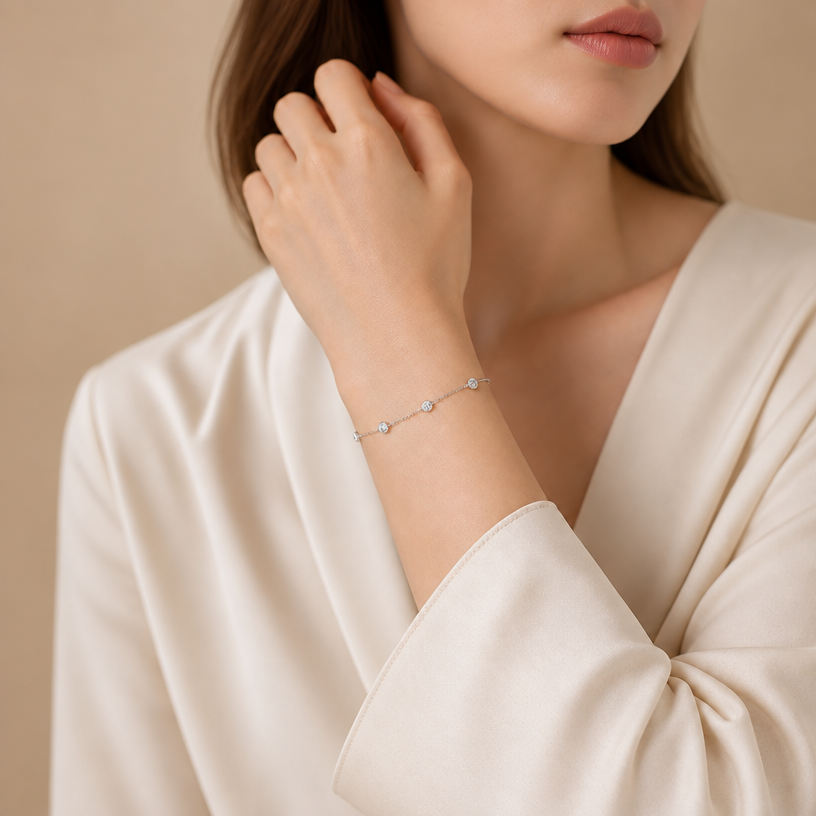 Jewelry photoshoot (worn)
Show the jewelry piece from the image worn by an elegant model in a professional editorial photograph, soft studio lighting. Reproduce the jewelry's exact design, metal, stones and details faithfully. Photorealistic, no text. Additional instructions: Take the uploaded reference image exactly as it is and do not alter, regenerate, or redesign any part of the original photo — keep the jewelry piece, its exact design, size, and placement completely unchanged. Do not modify the model's hand position, pose, skin, lighting, or the original composition in any way.
The only task is to reformat the image into Instagram Story dimensions — vertical aspect ratio 9:16 (1080x1920px). Extend the background naturally and seamlessly above and below the original photo to fill the new vertical space, matching the existing tones, lighting, and blur of the original background so the extension looks seamless and undetectable.
Keep the wrist, hand, and bracelet as the sharp, centered focal point of the composition, with balanced negative space added at the top and bottom from the background extension. Do not crop into or cut off any part of the jewelry, hand, or wrist — the entire piece must remain fully visible exactly as in the original image.