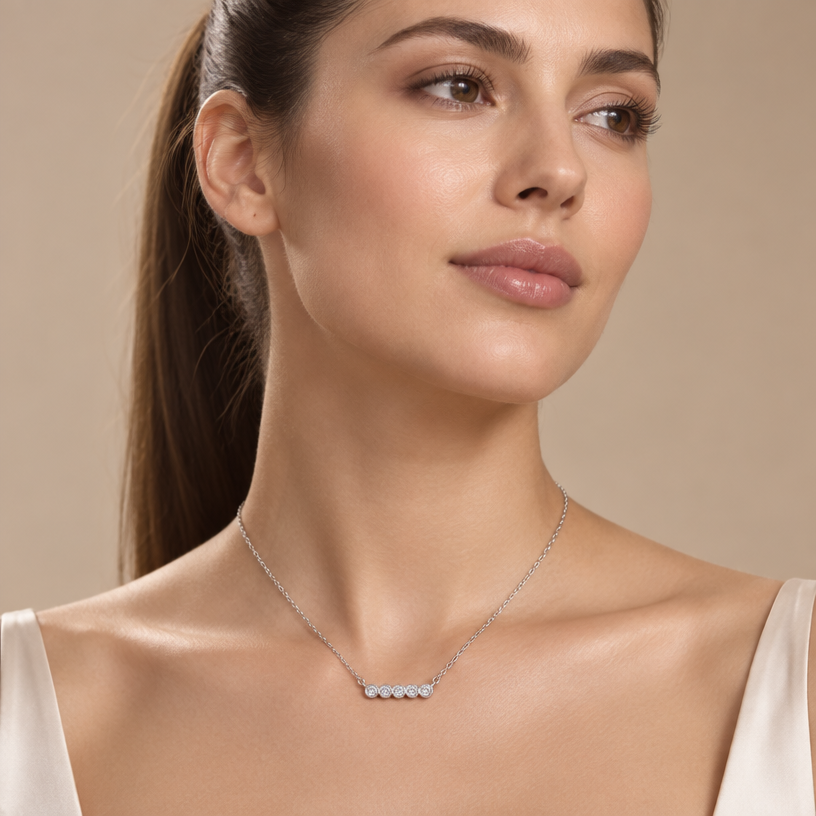 Jewelry photoshoot (worn)
Show the jewelry piece from the image worn by an elegant model in a professional editorial photograph, soft studio lighting. Reproduce the jewelry's exact design, metal, stones and details faithfully. Photorealistic, no text. Additional instructions: "Photorealistic, close-up editorial shot of an elegant young woman with soft, natural features, her hair pulled back into a sleek high ponytail, standing with her shoulders squared and chin gently lifted, a calm and confident expression on her face, eyes looking slightly off-camera. Soft studio lighting wraps gently around her neck and collarbone, creating a subtle, flattering glow. She is wearing a delicate, minuscule sterling silver necklace featuring a tiny polished cross pendant, resting naturally at the base of her throat. She is not wearing any earrings. Minimalist warm beige studio backdrop, shallow depth of field, sharp focus on the necklace and skin texture, soft bokeh elsewhere. 8k resolution, cinematic quality, luxury jewelry campaign aesthetic. Make sure the necklace chain stays as it is in the picture, meaning do not add any stones to it.
Jewelry scale note: the cross pendant must be tiny, delicate and realistically proportioned — not oversized or exaggerated, true to how fine jewelry actually looks in real life.".