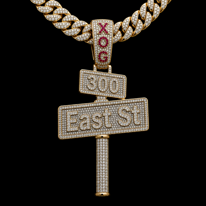 make a diamond pendent of a street sign the bottom sign say East St with a pole coming out the bottom going down 2 inch’s and the top sign say 300 and put it on a cuban link chain and on the bail connecting the pendent to the chain make it say XOG with red rubys
edit the attached jewelry design with these instructions: make a diamond pendent of a street sign the bottom sign say East St with a pole coming out the bottom going down 2 inch’s and the top sign say 300 and put it on a cuban link chain and on the bail connecting the pendent to the chain make it say XOG with red rubys. keep it photorealistic, just the design no text