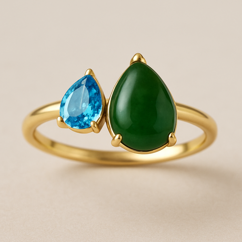 Toi et Moi Ring with a small pear shaped blue topaz and a slightly larger pear shaped nephrite jade stone