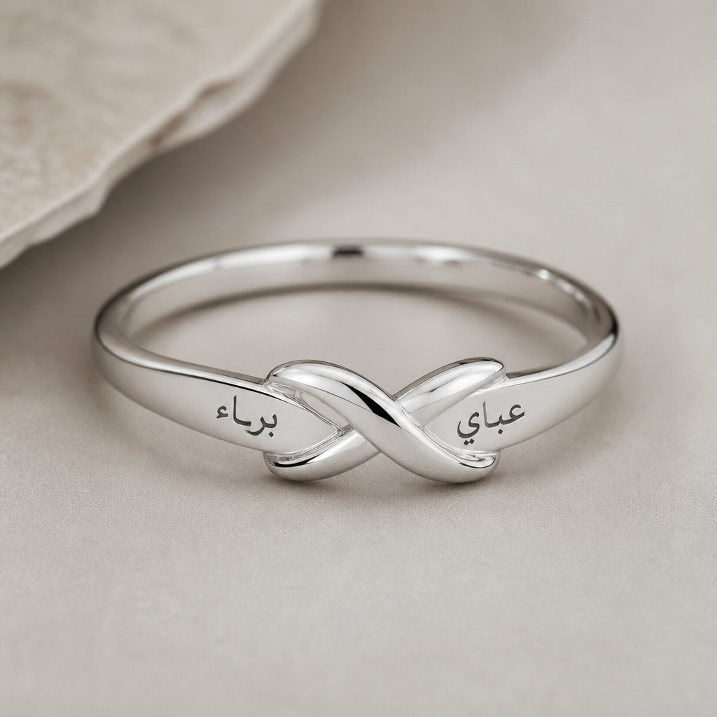 A women's ring made of silver suitable for daily wear. I want a simple, minimalist silver ring designed in a delicate, understated style. It should have the names 'Bara' and 'Obai' engraved in Arabic on it. I don't want it to be large or bulky, just elegant and refined
photorealistic jewelry design, A women's ring made of silver suitable for daily wear. I want a simple, minimalist silver ring designed in a delicate, understated style. It should have the names 'Bara' and 'Obai' engraved in Arabic on it. I don't want it to be large or bulky, just elegant and refined, modern style, just the design no text