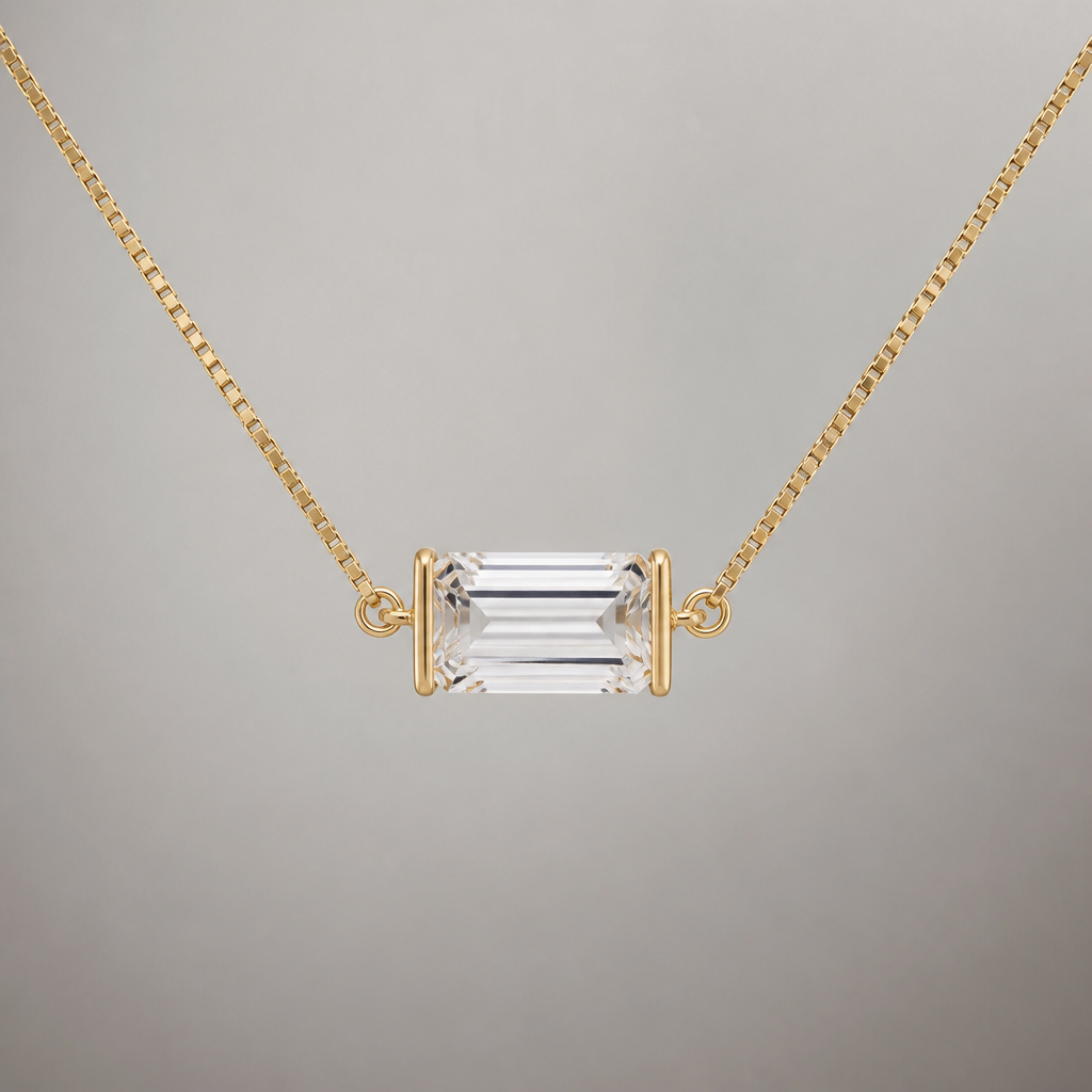 A 10ct clear emerald cut diamond with half bezel. The bezel is only on the left and right sides of the diamond. The diamond is east west on a thin box chain. All of the metal is yellow gold. The bezel is very thin and is a removable pendant that can be placed on different chains connects to the pendant in the middle of the diamond, not the top corners
photorealistic jewelry design, A 10ct clear emerald cut diamond with half bezel. The bezel is only on the left and right sides of the diamond. The diamond is east west on a thin box chain. All of the metal is yellow gold. The bezel is very thin and is a removable pendant that can be placed on different chains connects to the pendant in the middle of the diamond, not the top corners , minimalist style, just the design no text