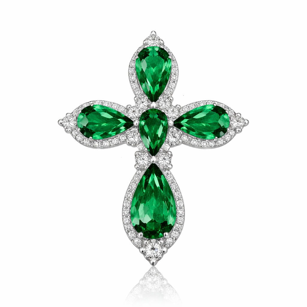 Pear cut emerald cross on 14k white gold with bale attached to the back and not shown. Few diamond accent stones. Classic, simple, and elegant