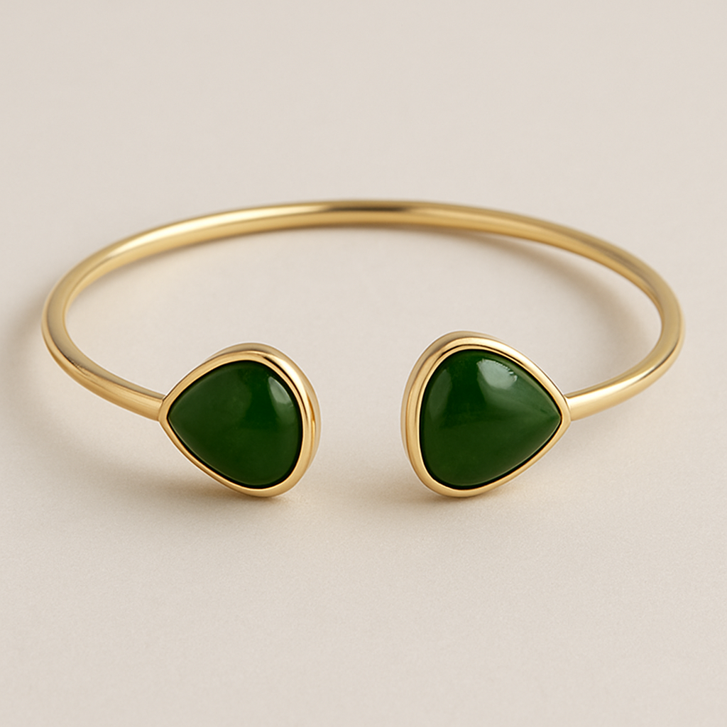 Create a 14k yellow gold bangle with two large pear shaped nephrite jade set in them