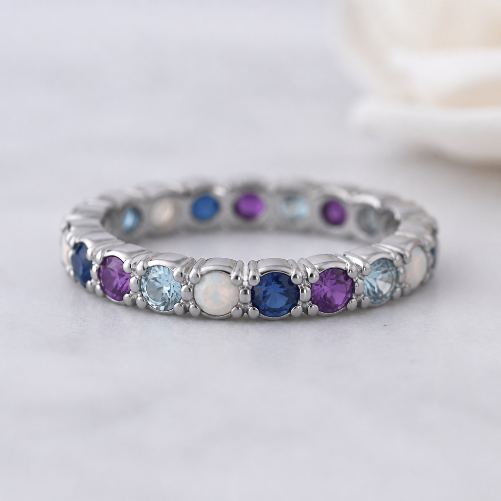 A eternity women's ring made of titanium with amethyst and aquamarine and opal and sapphire stones suitable for daily wear
photorealistic jewelry design, A eternity women's ring made of titanium with amethyst and aquamarine and opal and sapphire stones suitable for daily wear, eternity style, just the design no text
