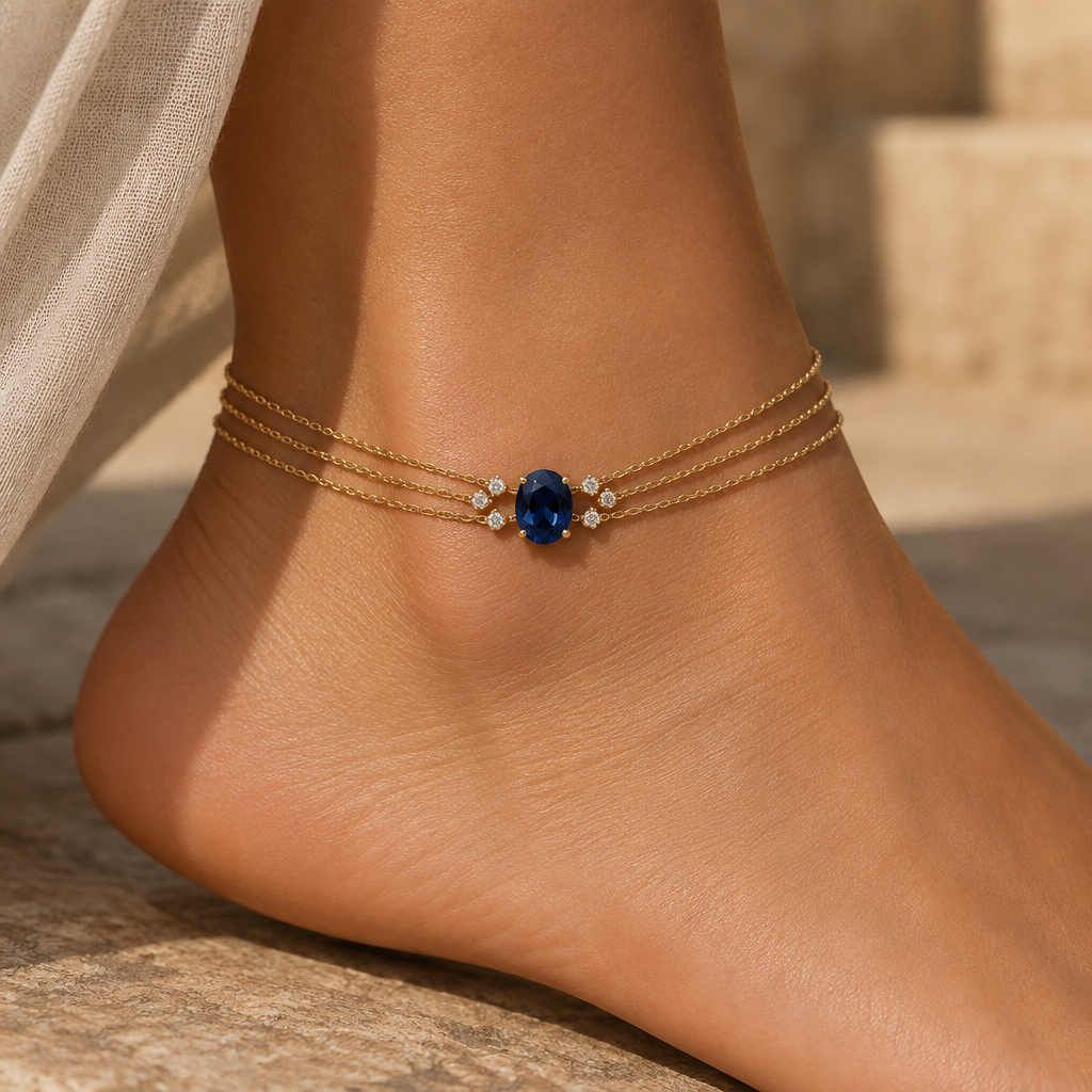 ANKLET
Maktūb centerpiece — revised
Keep the ~0.90 ct deep-blue oval sapphire as the unmistakable central stone.
Instead of six gold arms, we use 6 tiny white diamonds around the sapphire.
How they should be arranged
The six chains still come in as:
3 chains → 💎💎💎 → 💙 ← 💎💎💎 ← 3 chains
But the diamonds shouldn’t form a large halo.
They should be six very small, individual brilliant-cut diamonds, positioned at the six points where the chains converge toward the sapphire.
Think of them almost like six tiny points of light surrounding the blue stone.
✨ Proportions
I’d keep each diamond around 0.01–0.02 ct.
So approximately 0.06–0.12 ct total diamonds.
The sapphire remains dramatically larger than all six diamonds combined.
The visual effect
From the front:
gold chains → tiny white sparkle → deep-blue sapphire ← tiny white sparkle ← gold chains
The diamonds would catch light while walking, but they wouldn’t compete with the sapphire.
And symbolically, I really like this combination:
Gold = the six paths
Six diamonds = the moments of clarity/light along those paths
Blue sapphire = what is written 💙
Most importantly, there would still be exactly one central gemstone: the sapphire. The diamonds are only tiny supporting accents—not additional focal stones.
photorealistic jewelry design, ANKLET
Maktūb centerpiece — revised
Keep the ~0.90 ct deep-blue oval sapphire as the unmistakable central stone.
Instead of six gold arms, we use 6 tiny white diamonds around the sapphire.
How they should be arranged
The six chains still come in as:
3 chains → 💎💎💎 → 💙 ← 💎💎💎 ← 3 chains
But the diamonds shouldn’t form a large halo.
They should be six very small, individual brilliant-cut diamonds, positioned at the six points where the chains converge toward the sapphire.
Think of them almost like six tiny points of light surrounding the blue stone.
✨ Proportions
I’d keep each diamond around 0.01–0.02 ct.
So approximately 0.06–0.12 ct total diamonds.
The sapphire remains dramatically larger than all six diamonds combined.
The visual effect
From the front:
gold chains → tiny white sparkle → deep-blue sapphire ← tiny white sparkle ← gold chains
The diamonds would catch light while walking, but they wouldn’t compete with the sapphire.
And symbolically, I really like this combination:
Gold = the six paths
Six diamonds = the moments of clarity/light along those paths
Blue sapphire = what is written 💙
Most importantly, there would still be exactly one central gemstone: the sapphire. The diamonds are only tiny supporting accents—not additional focal stones., statement style, just the design no text