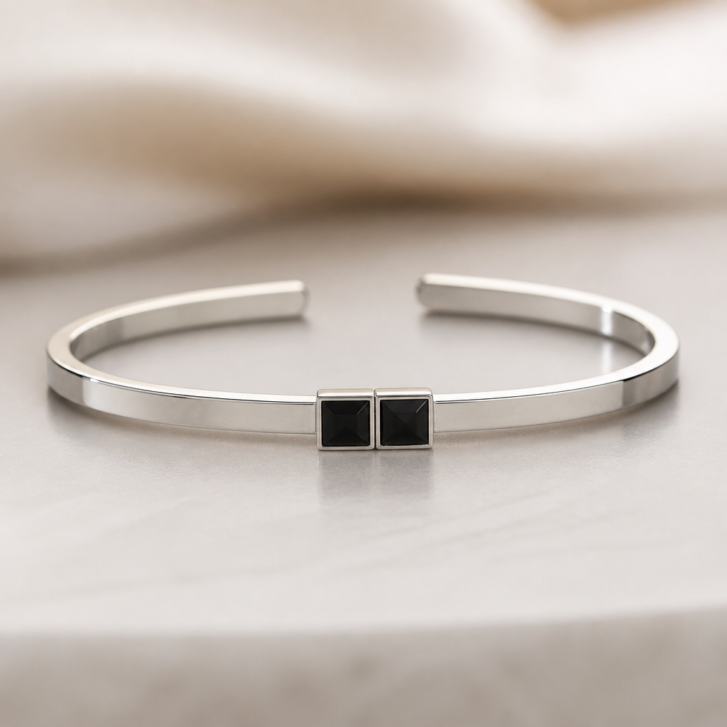 A women's bracelet made of silver. 2mm*6mm cuff bracelet with 2 black square stone in the middle
photorealistic jewelry design, A women's bracelet made of silver. 2mm*6mm cuff bracelet with 2 black square stone in the middle, modern style, just the design no text