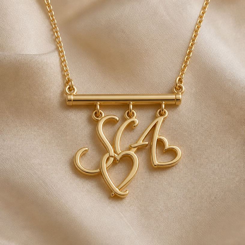 Hang the initials from a bar that’s attached to the necklace
